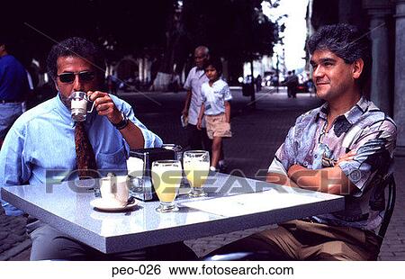 Two Men Sitting Drinking at an Outdoor Cafe View Large Photo Image Stock Photograph - Two Men Sitting Drinking at an Outdoor Cafe. Fotosearch