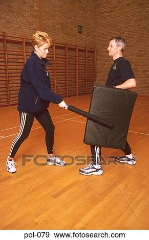 Stock Photo - Two Police Officers at Baton Training. Fotosearch