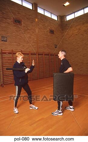 Stock Image - Two Police Officers Baton Training. Fotosearch