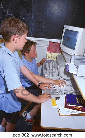 Stock Image - Two Primary School Children Using Computer. Fotosearch