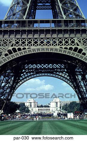 Stock Image - View through Arch of the Eiffel Tower Paris France. Fotosearch