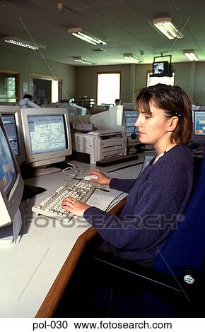 Stock Image - Woman in Police Office using Telephone Headset. Fotosearch