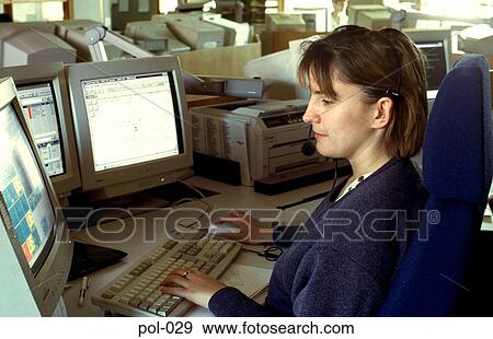 Stock Photo - Woman in Police Office using Telephone Headset. Fotosearch