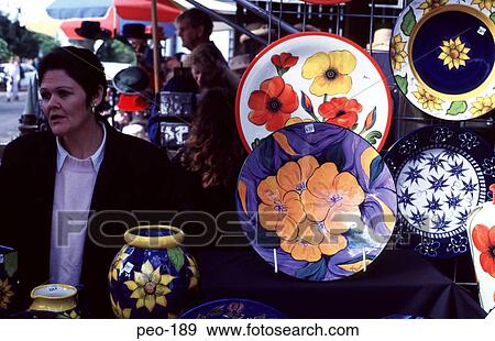 Stock Photo - Woman Selling Colourful Ceramics Australia. Fotosearch