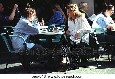Stock Photograph - Women Sitting and Talking in an Outside Cafe. Fotosearch