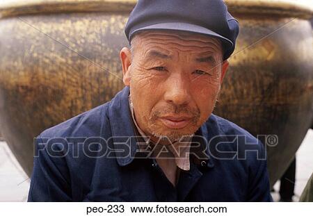 Stock Image - Workman in Overalls and Cap China. Fotosearch