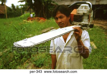 Stock Image - Workman with Chainsaw Iquitos Amazon Peru. Fotosearch