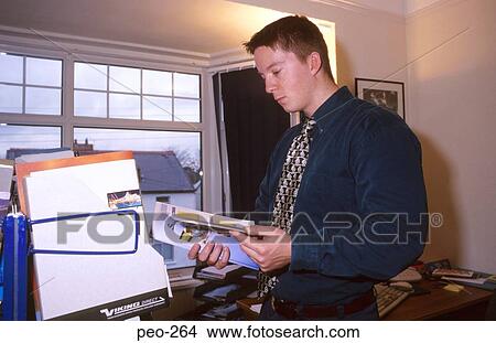 Picture - Young Executive Reading Brochure. Fotosearch