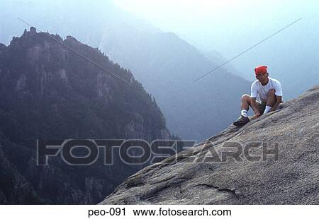 Young Man Sitting on Mountain Top Korea View Large Photo Image Stock Image - Young Man Sitting on Mountain Top Korea. Fotosearch