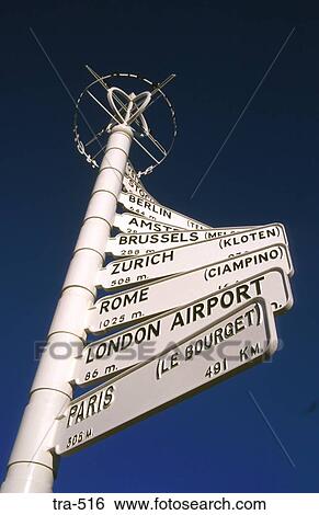 Stock Photograph - Arrows on International Signpost UK. Fotosearch