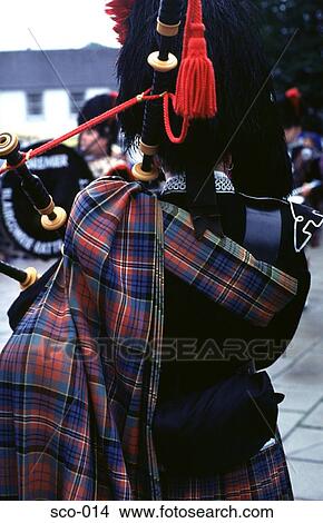 Picture - Back of Piper in Traditional Tartan Dress Scotland. Fotosearch