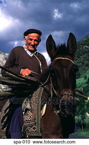 Stock Image - Close-up of Farmer on a Donkey Spain. Fotosearch