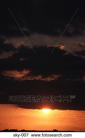 Stock Photo - Cumulus obscuring the Evening Sun. Fotosearch