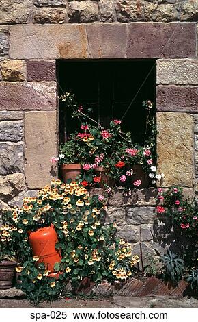 Stock Photography - Flowers around Window of Old House Spain. Fotosearch