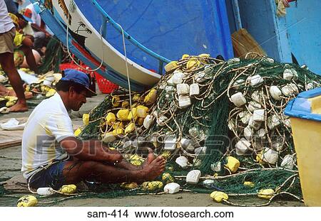 Picture - Man Checking Fishing Nets Musnie Ecuador. Fotosearch