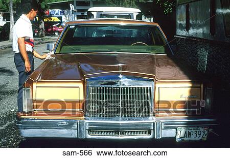 Stock Photograph - Man Polishing Luxury Car South America. Fotosearch