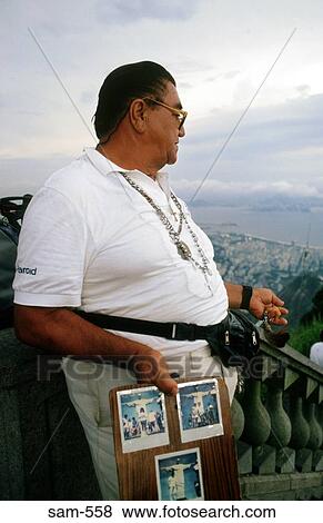 Stock Photo - Man Selling Photos of Christ Figure Rio Brazil. Fotosearch