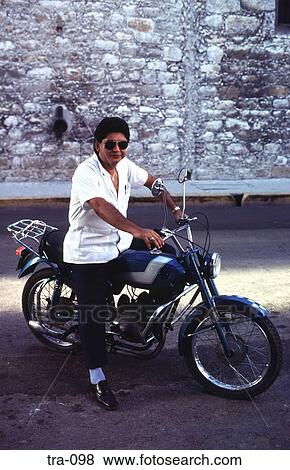 Stock Photo - Man Sitting on a Blue Moped Mexico. Fotosearch