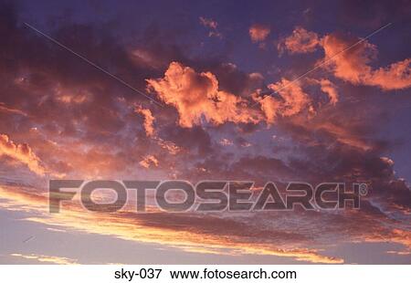 Stock Photo - Orange Highlighted Clouds at Sunset. Fotosearch