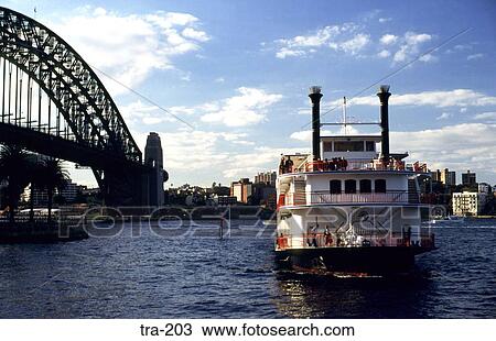 Stock Image - Paddle Steamer passing Sydney Harbour Bridge. Fotosearch