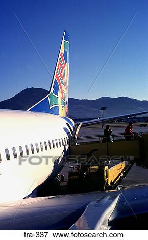 Stock Photo - People Disembarking From Colourful Airbus. Fotosearch