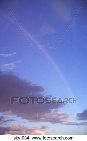 Rainbow in a Blue Sky View Large Photo Image Picture - Rainbow in a Blue Sky. Fotosearch