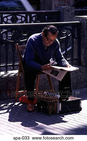 Stock Image - Shoe Shine Man Reading Newspaper Barcelona Spain. Fotosearch
