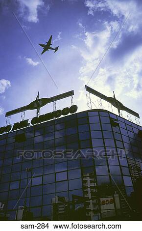 Silhouetted Aeroplane over Modern Building Venezuela View Large Photo Image Picture - Silhouetted Aeroplane over Modern Building Venezuela. Fotosearch