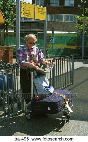 Traveller Waiting for Bus London Heathrow Airport UK View Large Photo Image Stock Photography - Traveller Waiting for Bus London Heathrow Airport UK. Fotosearch