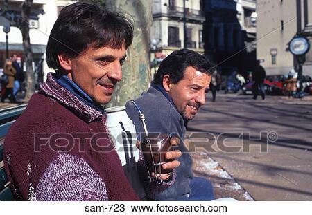 Stock Image - Two Yerba Mate Drinkers on Montevideo Street Uruguay. Fotosearch