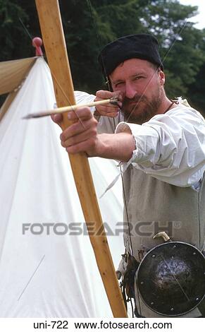 Stock Image - Archer in Medieval Costume Aiming UK. Fotosearch