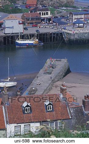 Boat near Whitby Harbour Entrance UK View Large Photo Image Stock Photo - Boat near Whitby Harbour Entrance UK. Fotosearch