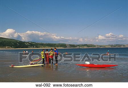 Stock Image - Canoes Sandy Beach Gower Wales. Fotosearch