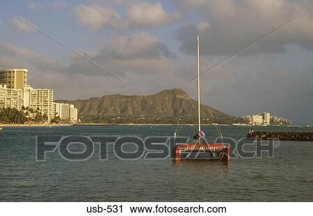 Stock Image - Catamaran on Lagoon Waikiki Beach Honolulu Oahu Hawaii USA. Fotosearch