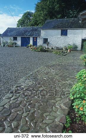 Stock Image - Cobbled Farmyard and Buildings UK. Fotosearch