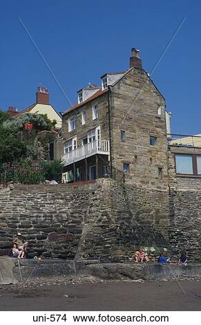 Cottage on Sea Wall Robin Hoods Bay UK View Large Photo Image Picture - Cottage on Sea Wall Robin Hoods Bay UK. Fotosearch
