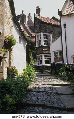 Stock Photograph - Cottages by Steep Cobbled Street UK. Fotosearch