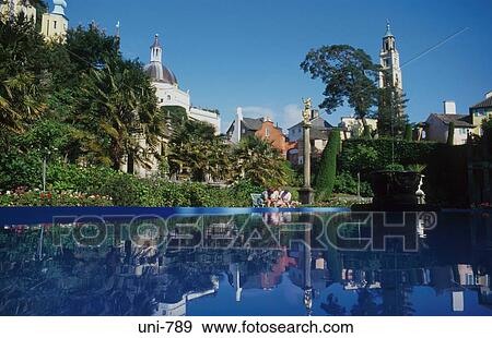 Stock Photo - Cottages Reflected in Village Pond Portmeirion Wales UK. Fotosearch