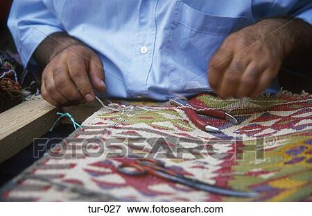 Stock Photo - Craftsman Sewing Carpet Istanbul Turkey. Fotosearch