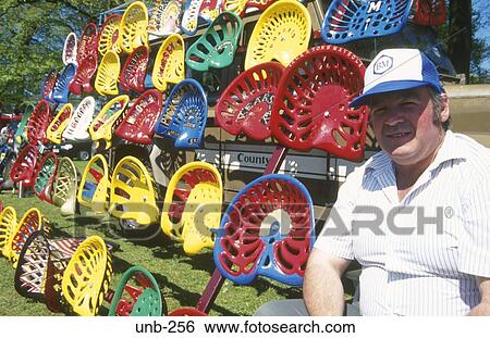 Stock Photograph - Display of Painted Tractor Seats. Fotosearch