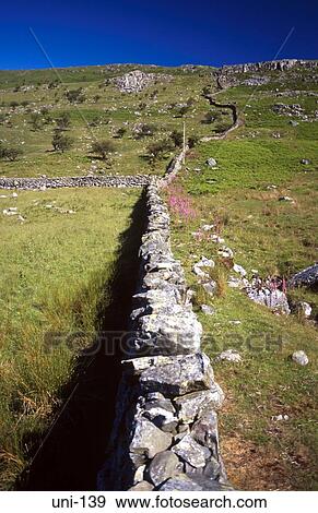 Stock Photo - Dry Stone Wall Bisecting Landscape Wales UK. Fotosearch