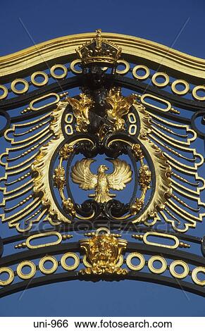 Stock Photograph - Gilded Crest Buckingham Palace London UK. Fotosearch