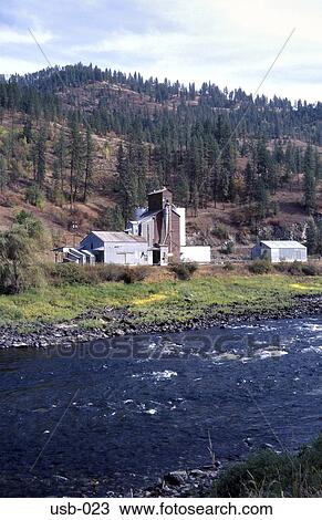 Stock Image - Grain Silos by River Washington State USA. Fotosearch