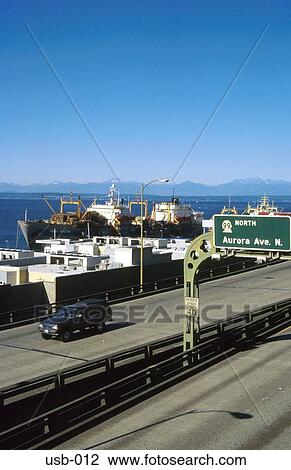 Stock Image - Highway Passing Docked Ships Seattle USA. Fotosearch