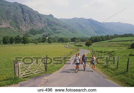 Hikers on Country Road Lake District UK View Large Photo Image Stock Photograph - Hikers on Country Road Lake District UK. Fotosearch