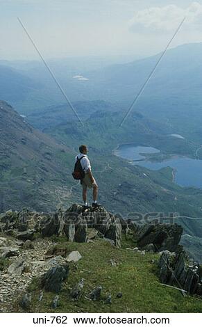 Man on Peak Looking at Surrounding Mountains Wales UK View Large Photo Image Stock Image - Man on Peak Looking at Surrounding Mountains Wales UK. Fotosearch
