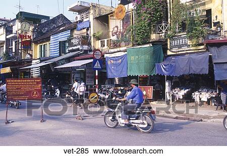 Stock Photography - Moped Travelling along Street Hanoi Vietnam. Fotosearch