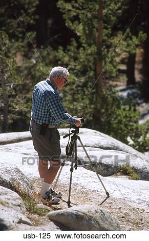 Photographer Setting Up Camera on Tripod USA View Large Photo Image Stock Photography - Photographer Setting Up Camera on Tripod USA. Fotosearch