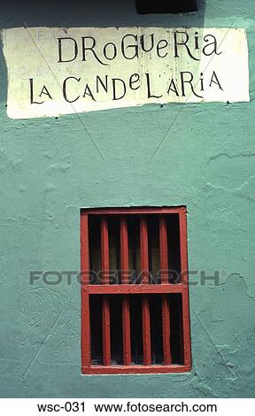 Stock Image - Red Window in Green Wall Colombia. Fotosearch