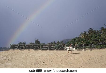 Surfer and Rainbow Hawaii USA View Large Photo Image Stock Photo - Surfer and Rainbow Hawaii USA. Fotosearch